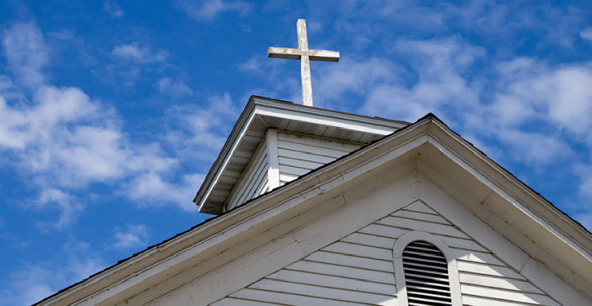 Photo of a cross atop a church building