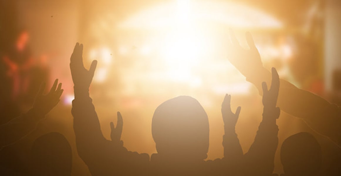 Image of a silhouetted crowd at a worship service