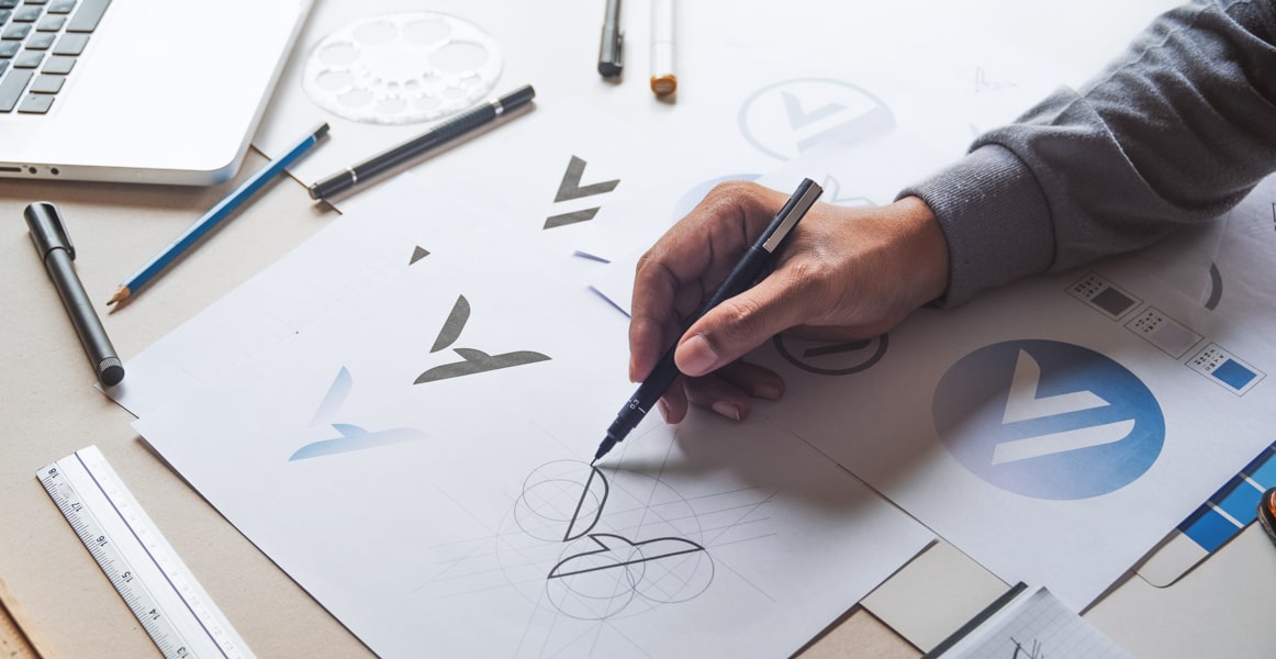 Close-up of a person sketching logo ideas