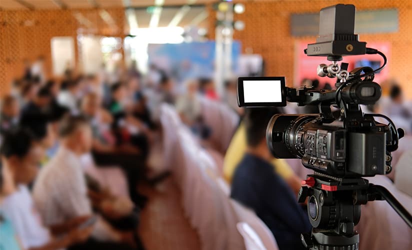 Camera pointed and ready to broadcast a large church event